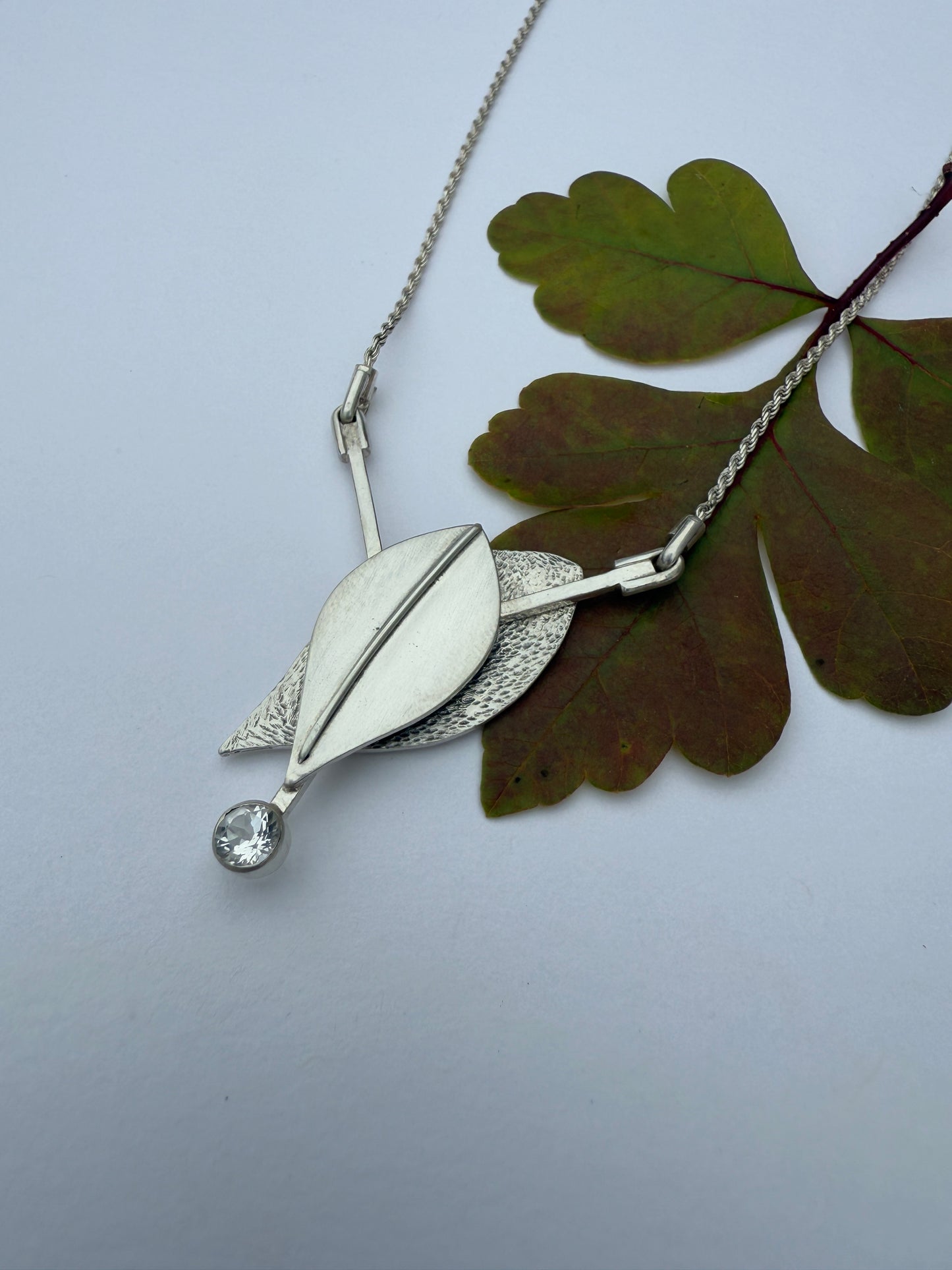 Radiant Renewal Necklace: Sterling Silver & White Topaz Leaf Pendant