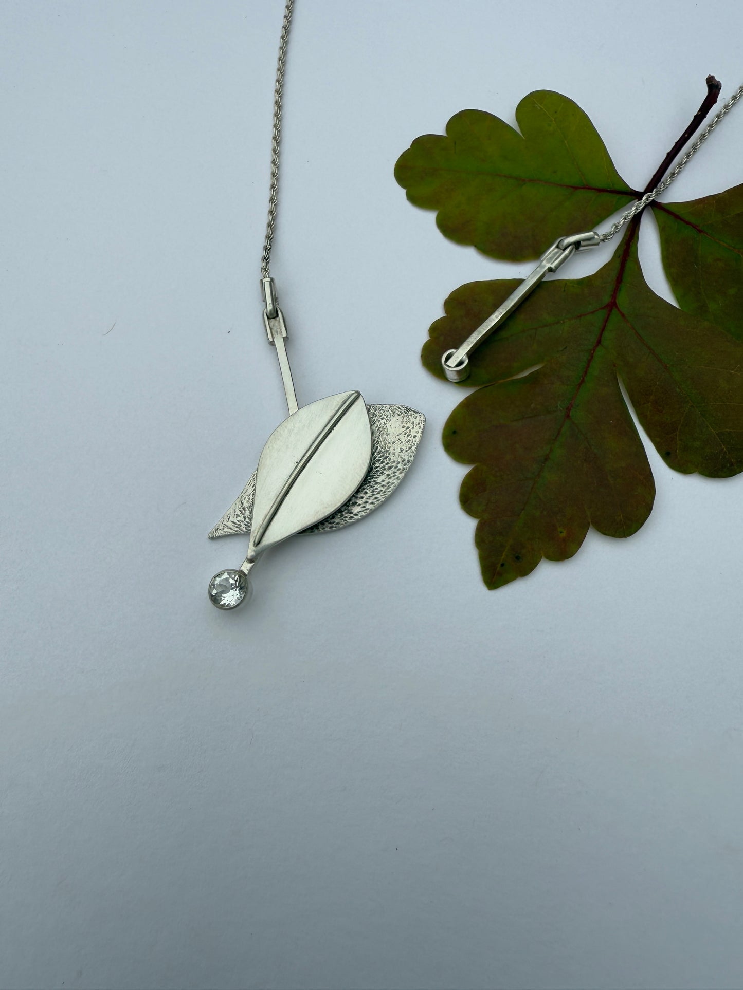 Radiant Renewal Necklace: Sterling Silver & White Topaz Leaf Pendant