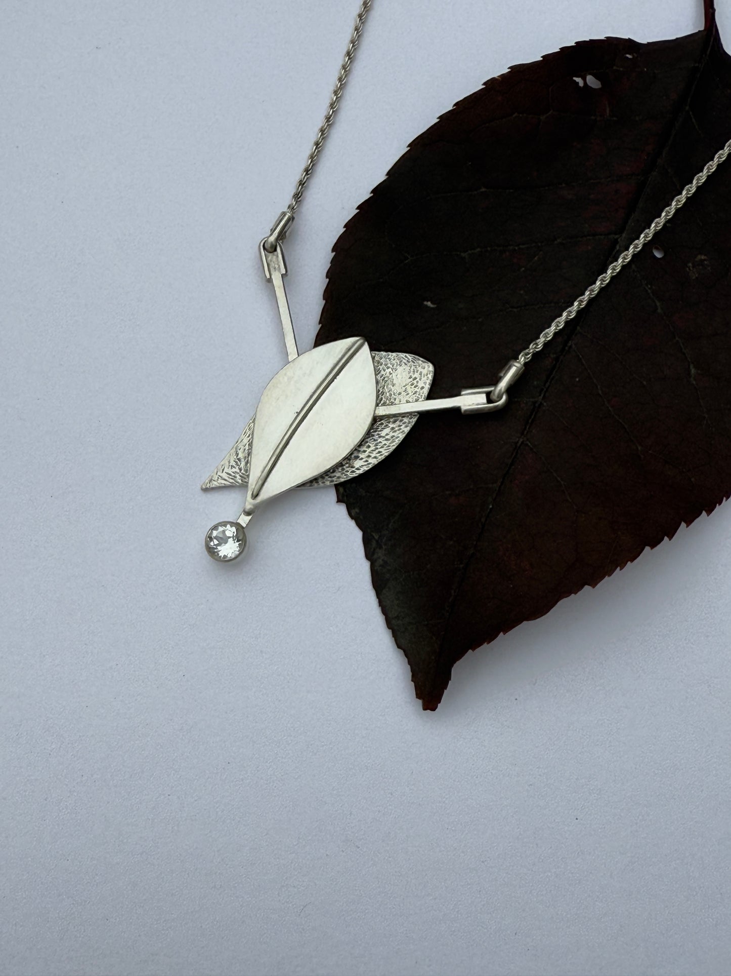 Radiant Renewal Necklace: Sterling Silver & White Topaz Leaf Pendant