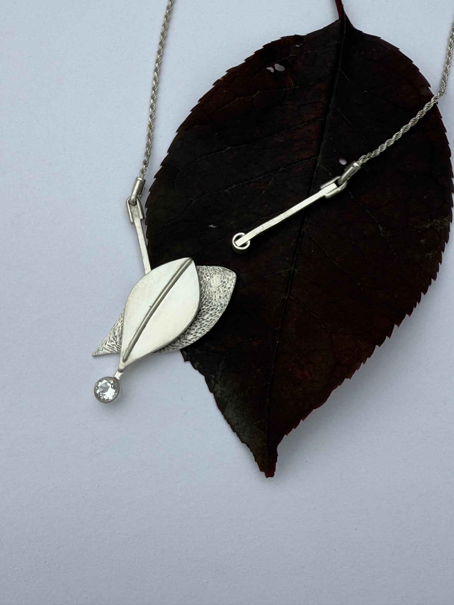 Radiant Renewal Necklace: Sterling Silver & White Topaz Leaf Pendant